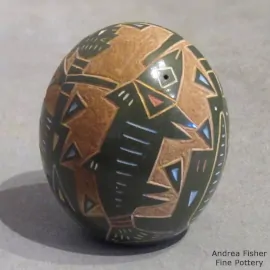 Fish, dancer and geometric design on a miniature polychrome seed pot
