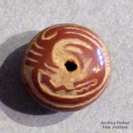 Sgraffito avanyu design on a miniature red seed pot