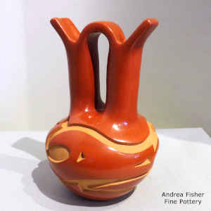Red wedding vase with a carved avanyu design