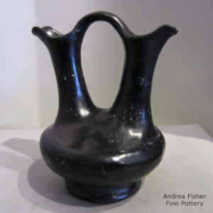 A plain black wedding vase with a foot