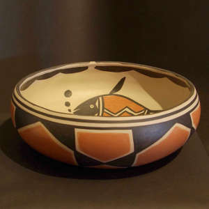 A fish and geometric design inside, geometric design outside on a polychrome bowl