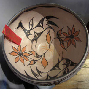 Birds and floral design inside and geometric design outside on a polychrome dough bowl