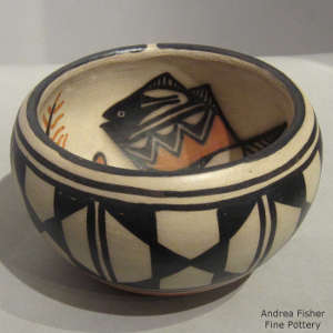 Fish and floral design inside and geometric design outside on a polychrome bowl