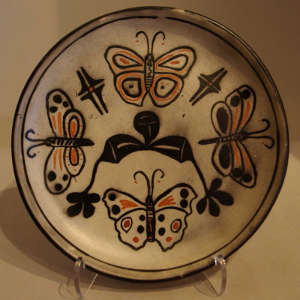 Butterfly and geometric designs on a polychrome plate