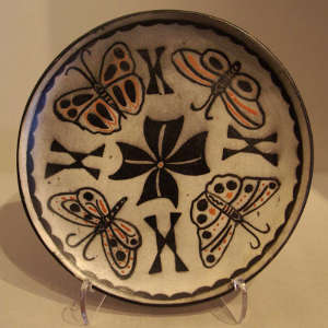 Butterfly and geometric design on a polychrome plate