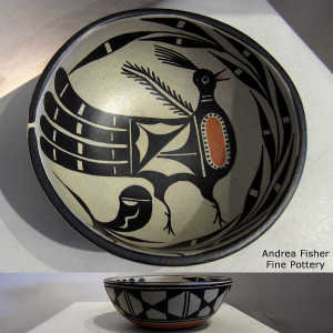 Geometric design outside and bird and plant design inside a polychrome bowl
