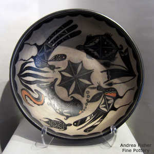 Geometric design outside and bird, animal and geometric design inside a polychrome bowl