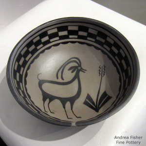 Deer, plant and geometric design inside and geometric design outside on a polychrome bowl