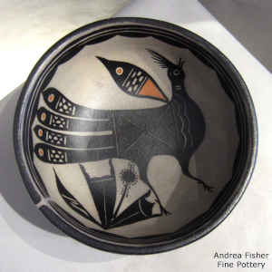 Bird and cactus design inside and geometric design outside on this polychrome bowl