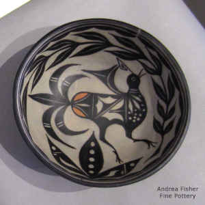 Bird and flower design inside and geometric design outside on this polychrome chili bowl