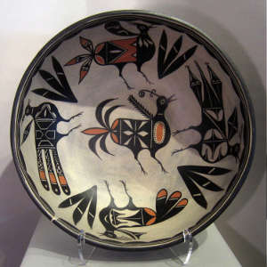 Bird and geometric design inside with geometric design outside on a large polychrome bowl