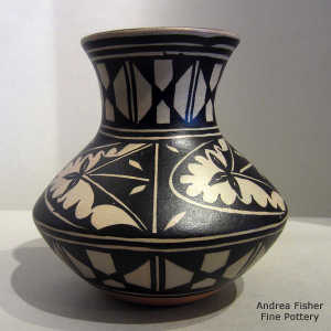 Black and white geometric design on a polychrome jar