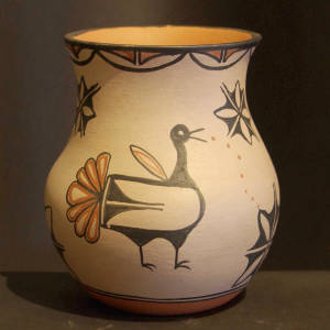 Flower, bird and star designs on a polychrome jar