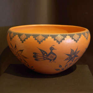 Black bird, flower and geometric design on a golden micaceous bowl