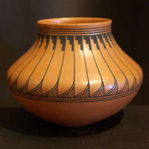 Feather pattern painted around the shoulder of an orange micaceous jar
