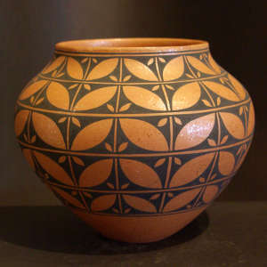 Leaf pattern design on an orange micaceous jar