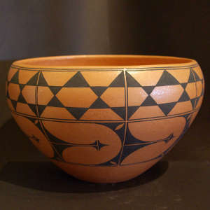 Geometric design on an orange micaceous bowl
