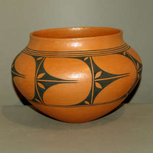 Geometric design on an orange micaceous pot