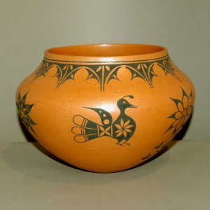 Bird, flower and geometric design on a golden micaceous jar