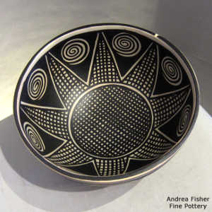 Spiral and geometric design inside and out on a polychrome bowl