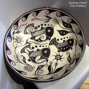 Fish, water and geometric design inside and geometric design outside on a polychrome bowl