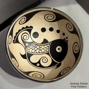 Fish and water design  inside and water design outsode on a polychrome bowl