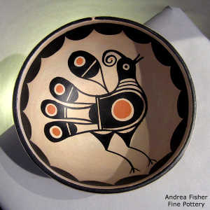 Geometric design outside and bird and geometric design inside on a polychrome bowl