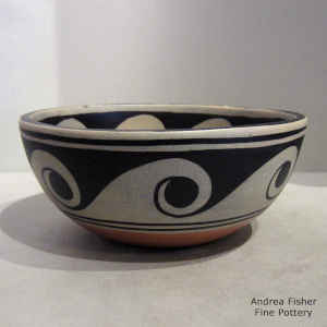 Turtle and wave design inside, wave design outside on a polychrome bowl