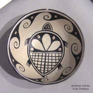 Turtle and wave design inside, wave design outside on a polychrome chili bowl