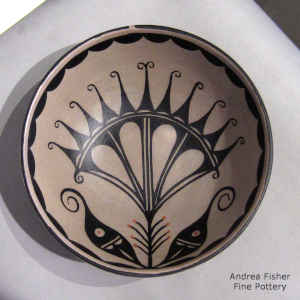 Cotton flower and geometric design inside, geometric design outside on a polychrome chili bowl