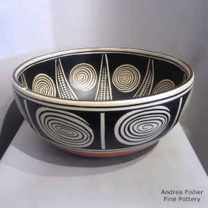 Spiral and geometric design inside and out on a polychrome bowl