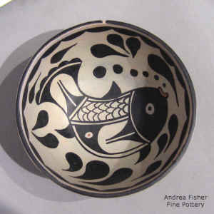 Fish, bubble and geometric design inside, water wave geometric design outside on a polychrome chili bowl