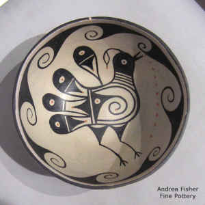 Bird and geometric design inside, geometric design outside on a polychrome bowl