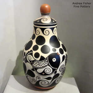 Fish, water, polka dot and geometric design on a polychrome lidded jar