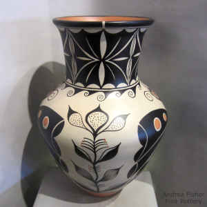 Flower, butterfly, water and geometric design on a polychrome jar