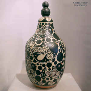 Bold fish and geometric design on a polychrome lidded jar