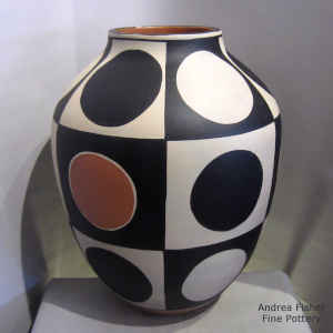 A polka dot geometric design on a polychrome jar