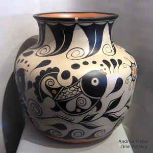 Bold fish, water, plant and geometric design on a polychrome jar