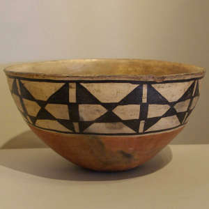 Leaf design inside and geometric design outside on a polychrome bowl