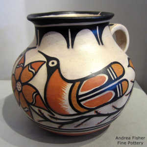 Floral, bird and geometric design on a polychrome pitcher