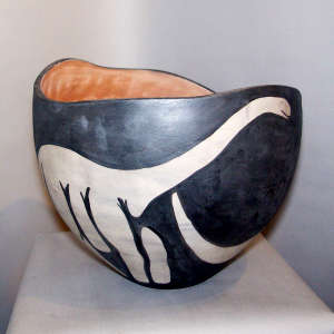 Several dinosaurs on a polychrome bowl with an organic undulating rim