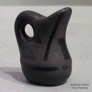 A geometric design a black on blcak miniature water pitcher