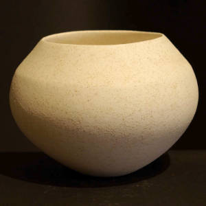 Rough micaceous slip on a white jar