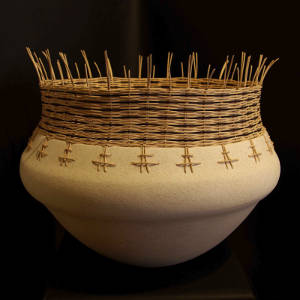 Basket weaving around top of a white jar with a rough micaceous slip