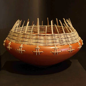 Basket weaving around the rim of a smooth red bowl