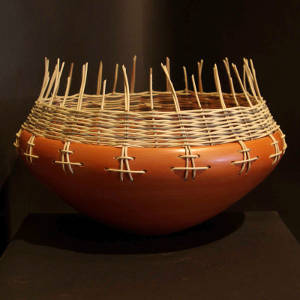 Basket weaving around the rim of a smooth red bowl