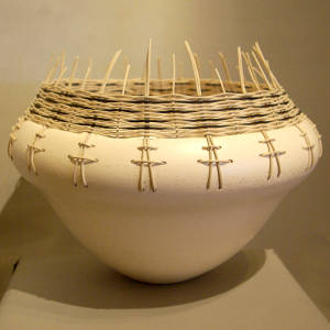 Basket weave around the rim of a white micaceous organic shape