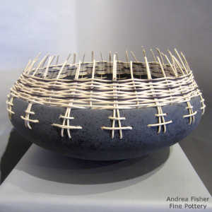 Basket weave around the rim of a micaceous black bowl