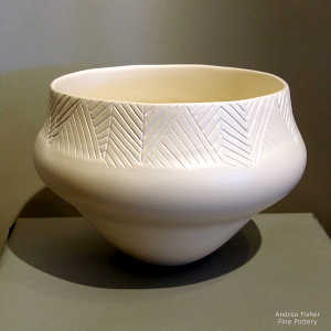 Lightly carved geometric design on a white bowl