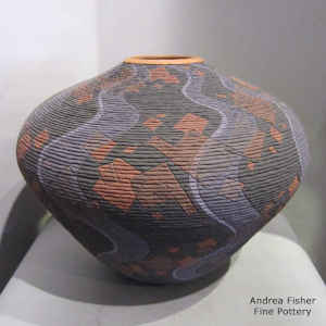 A tiny coil polychrome jar with a sgraffito and painted geometric design